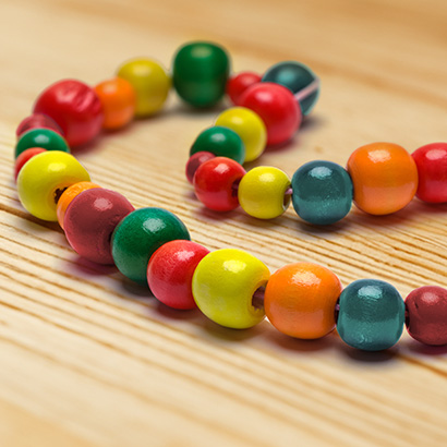 bead necklace on wooden table