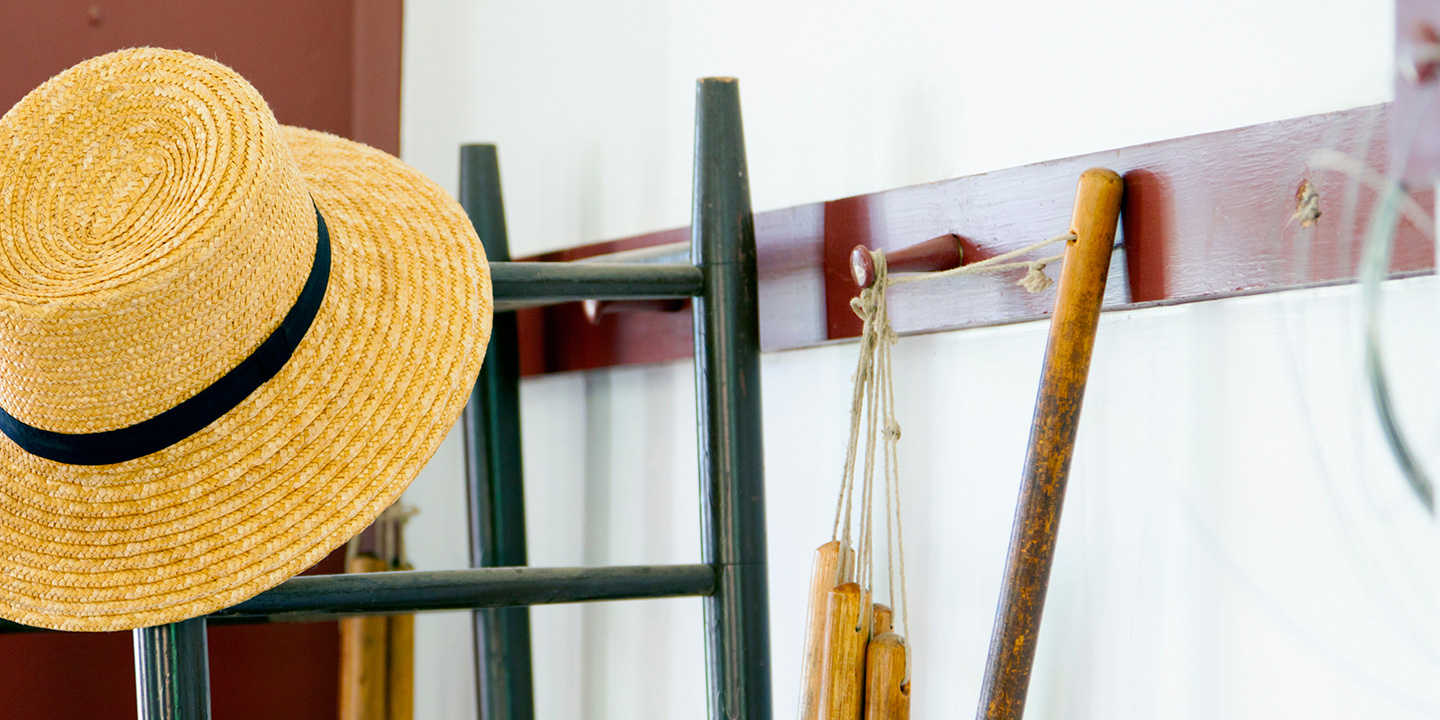 shaker peg rack with chair and hat hanging